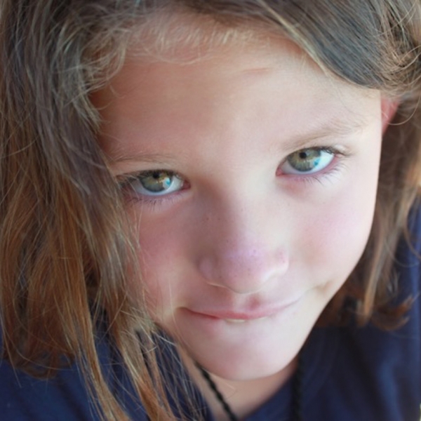 adolescent girl looks into camera close-up