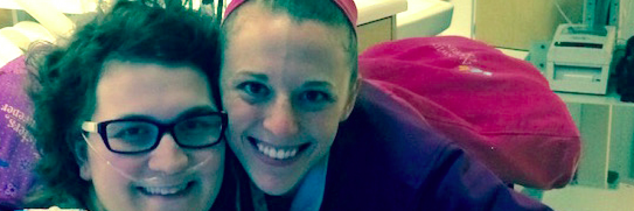 The Moment My Nurse Became My Hero Contributor wearing a hospital gown and nose cannula smiling with nurse