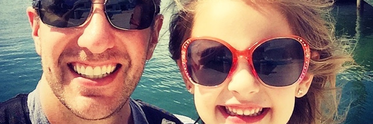 How My Daughter With Type 1 Diabetes Helps Others dad and daughter in front of a lake