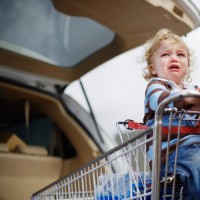 Mother Pushing Son in Shopping Cart