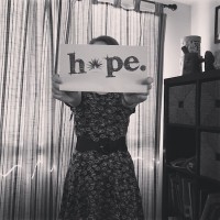 woman holding hope sign