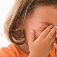Young girl indoors crying