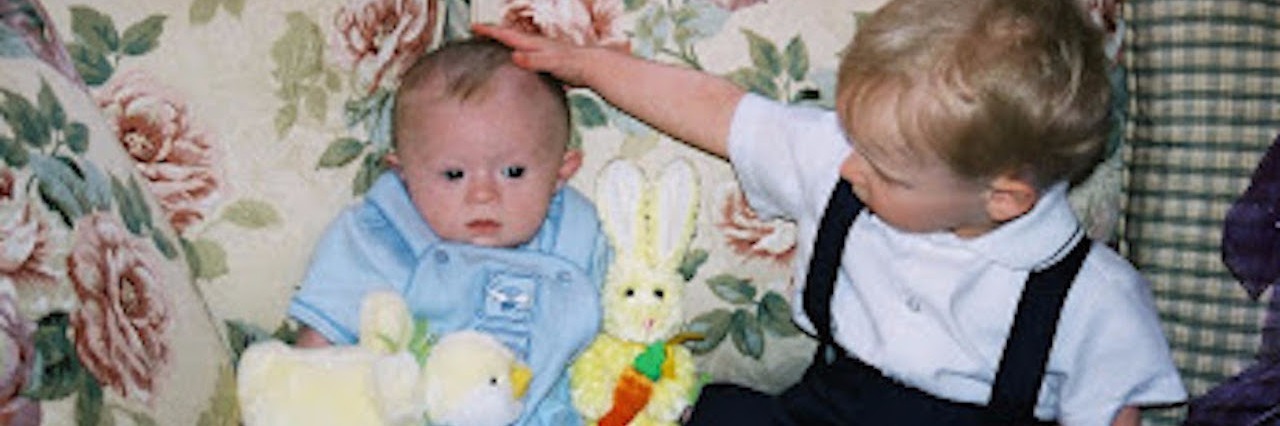 author's son sitting on the couch during easter with his brother