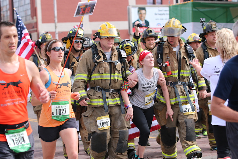 firefighters help kayley cross the finish line
