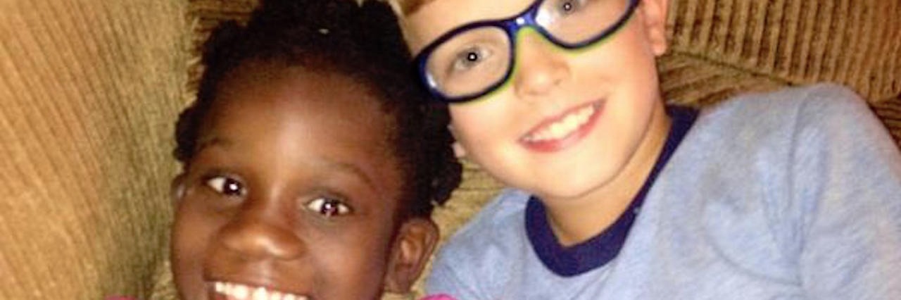 Seeing Disability Through a Sibling's Eyes brother and sister sitting on a couch