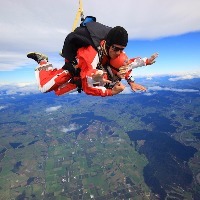 woman skydiving above new zealand