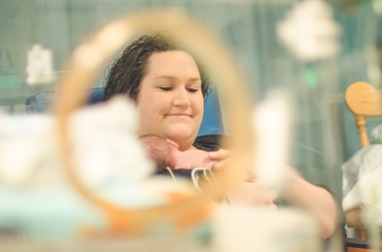 view of mom and preemie through incubator