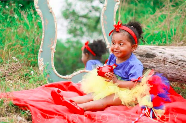 young girl wearing snow white costume