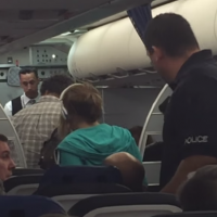 Family being escorted off plane