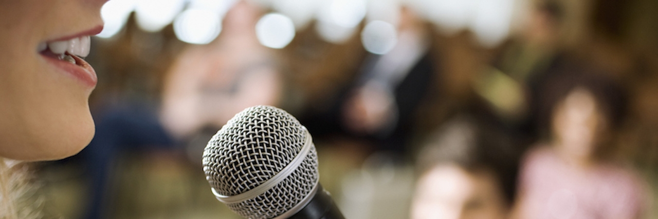 Tips for Interacting With People Who Stutter woman speaking into microphone