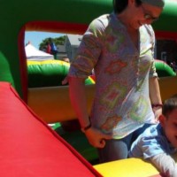 mom with her son on a bounce house