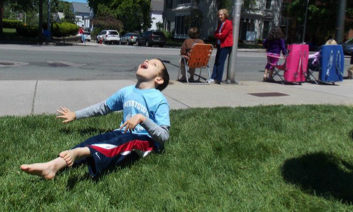 boy laughing on grass