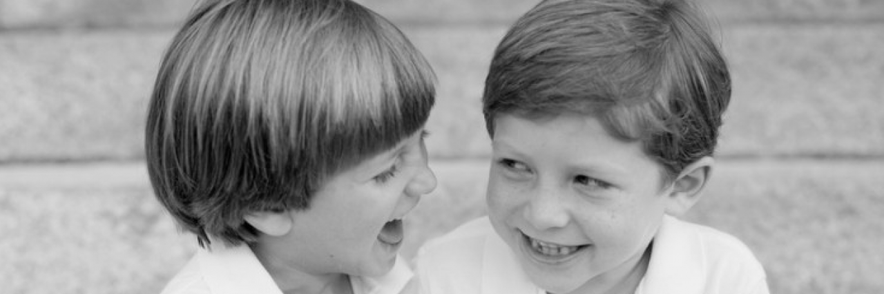 Black and white photo of brothers smiling and laughing