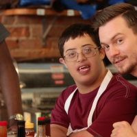 Two young men smile for camera.