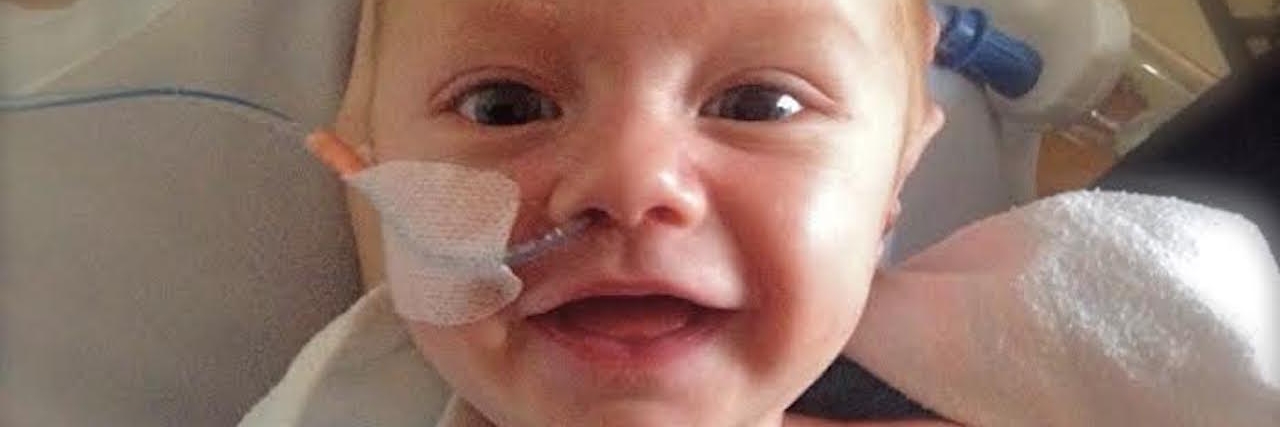 Heart Defect: Why It's OK That My Son Can't Be Anything He Wants to Be A small baby boy, smiles for camera with wires attached to his nose and his chest.