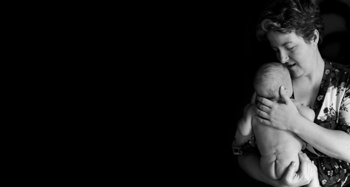 Black and white photo of mom holding baby