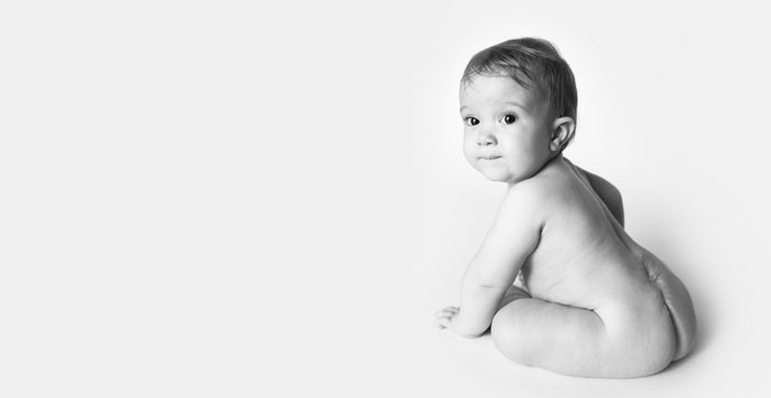 Black and white photo of baby from behind
