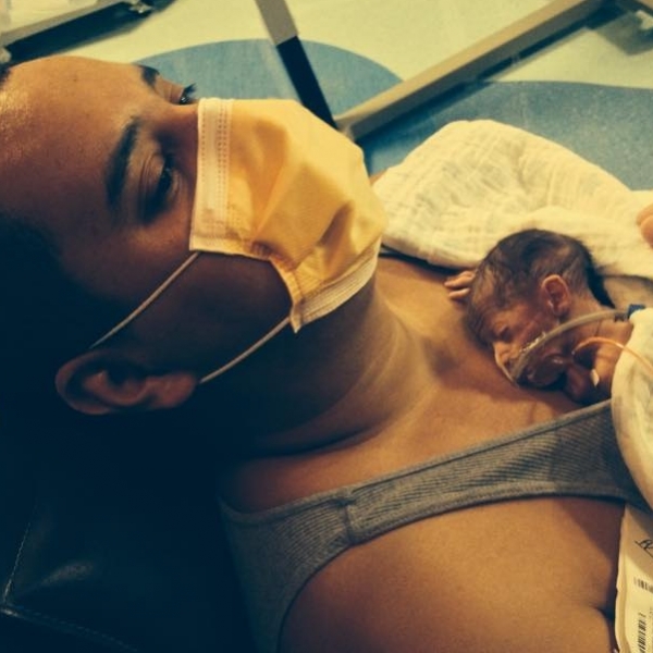 Dad holding baby in hospital
