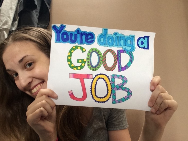 Catherine Richardson holding sign that says you're doing a good job