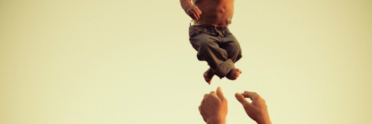 Receiving Jarring Comments About My Son With a Heart Condition arms throw a baby boy up into the air