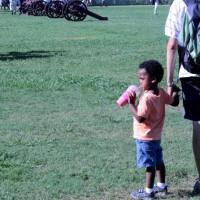 Father holding son's hand on soccer field