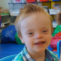 A small boy smiling for camera