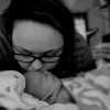 mom kissing baby in hospital