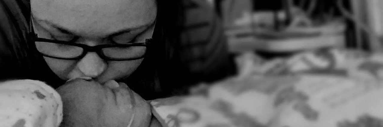 Don't Compare Yourself to Those 'Perfect' Moms on Facebook mom kissing baby in hospital