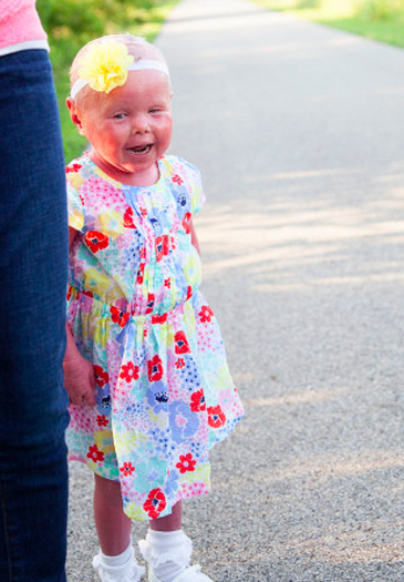 author's daughter in flower dress smiling