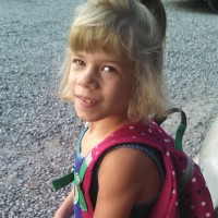little girl wearing a backpack