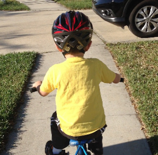 young child on bicycle outdoors
