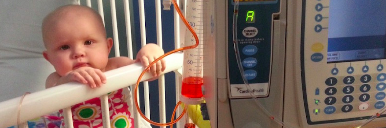Not Celebrating When Infant Leukemia Chemo Treatment Ends Baby girl sitting up in bed at hospital