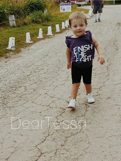 Little girl walking on a track. 