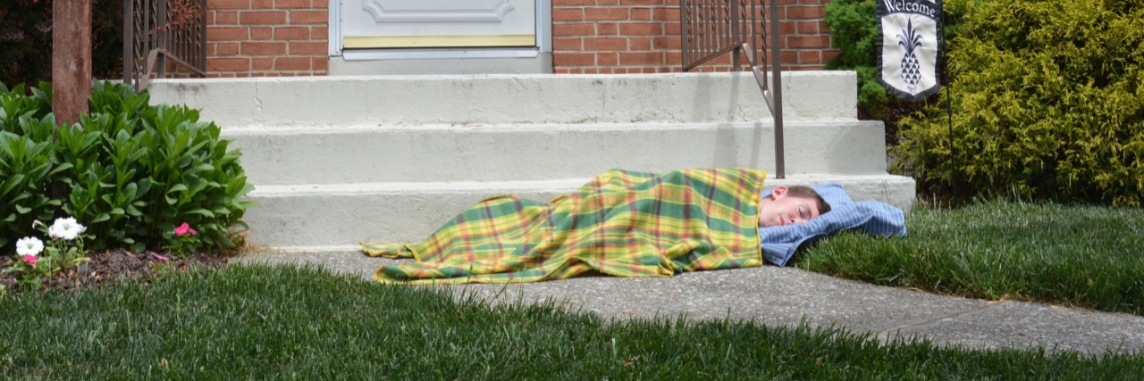 Shane Burcaw: Memes Use Humor to Teach About Spinal Muscular Atrophy Meme of boy laying in front of porch with blankets that says, "This is where I'd sleep if my house had no wheelchair ramp."