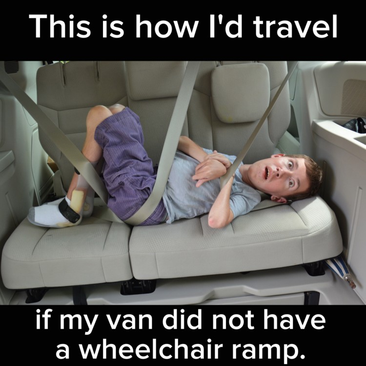 Shane lays in a car, strapped in with seat belts. Text reads: This is how I'd travel if my van did not have a wheelchair ramp.