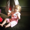 young girl in pink outfit playing with bubbles