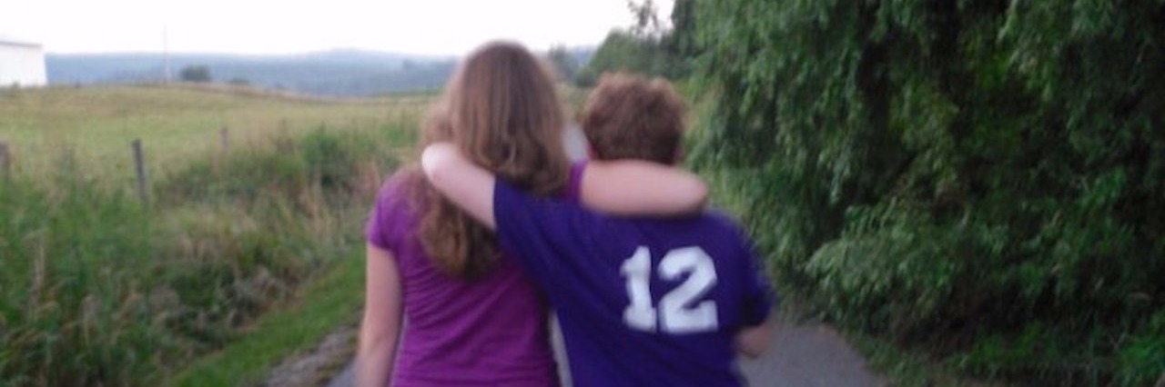 Tips for Having a Sibling With a Mental Illness sarah schuster walks down a road with her arm around her brother