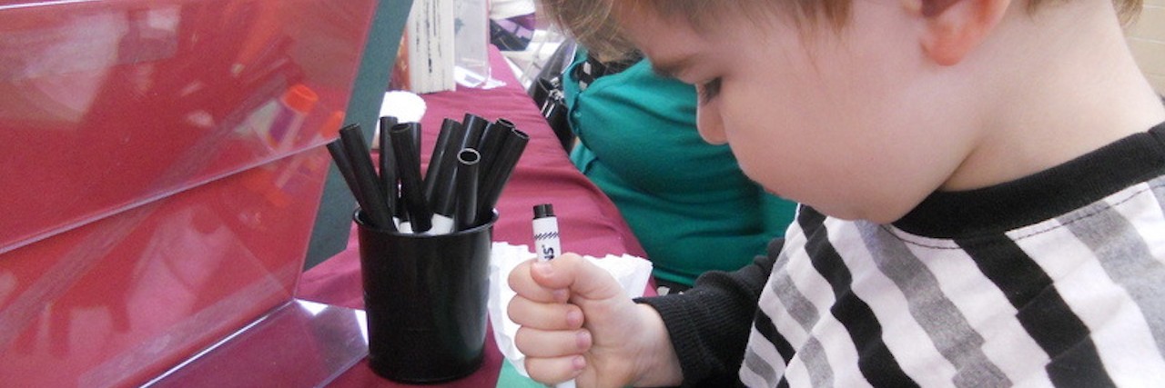 When I Didn't Recognize the Woman Next to My Son With Autism little boy coloring