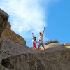 Elise Free with her daughter on a hike. their hands are high in the air
