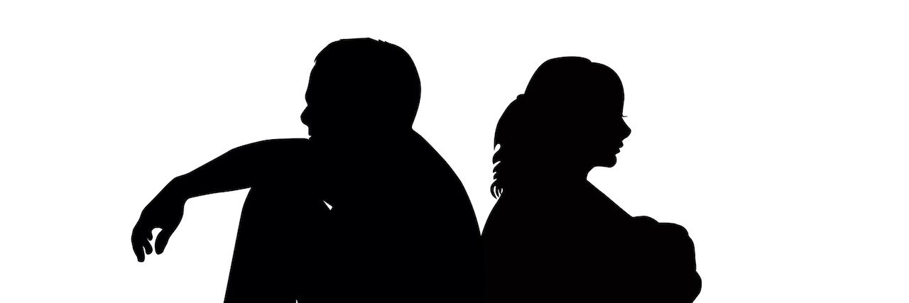 Silhouette of couple sitting back to back