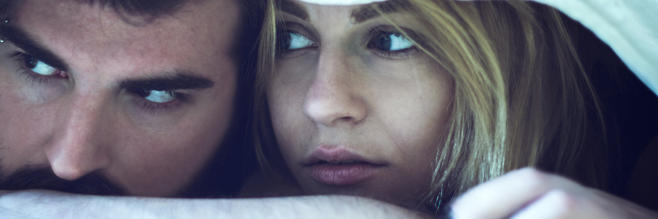 How to Explain Depression to Your Husband, a Letter From a Wife A couple hiding under blankets, looking at each other