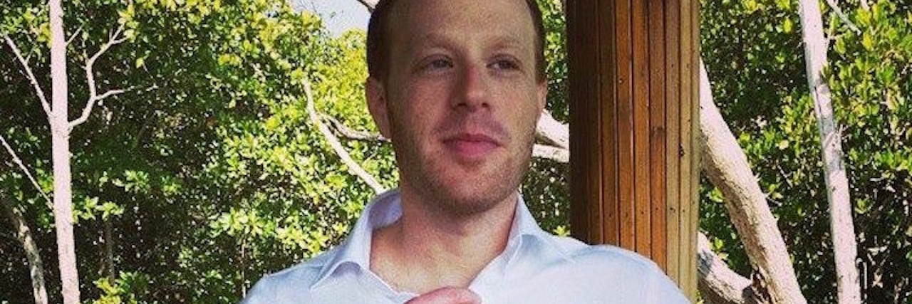 How to Support a Loved One With a Chronic or Invisible Illness A man stands adjusting his tie