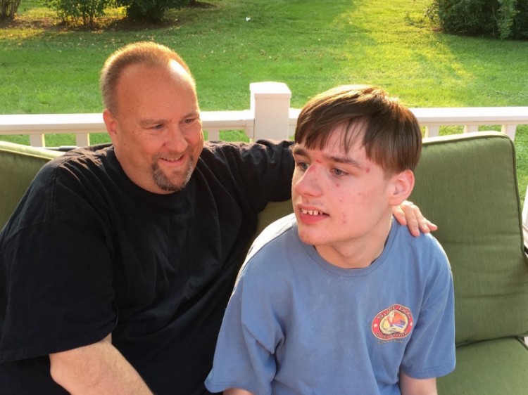 father sitting outside with his son