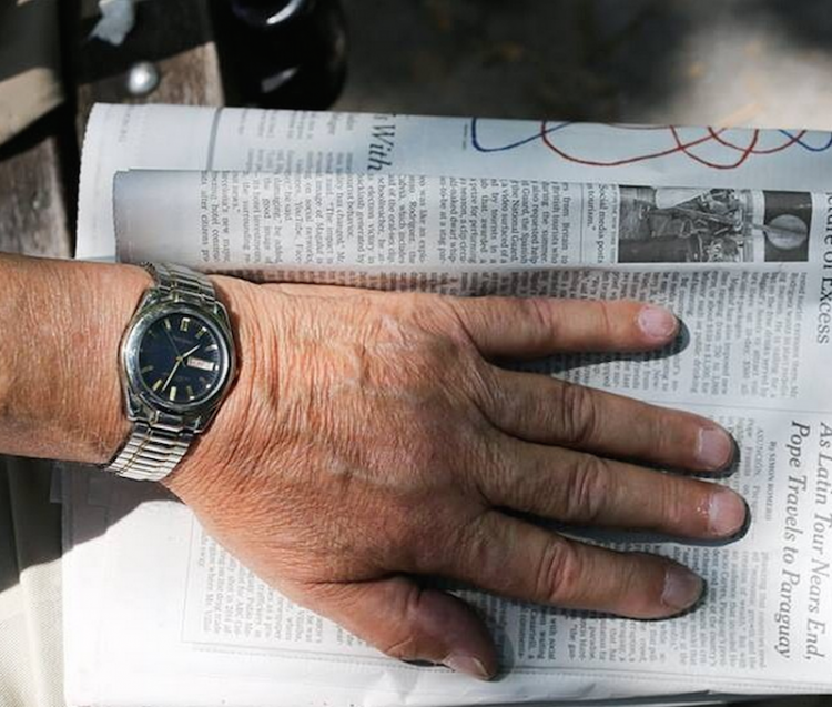 man holding newspaper