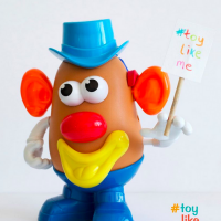 A Mr. Potato Head toy with an earpiece/hearing aid