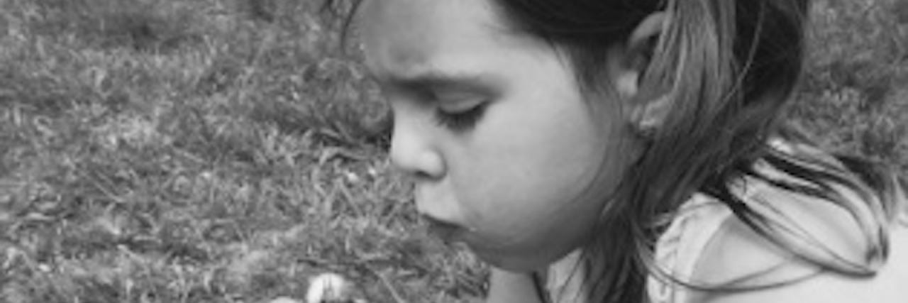 Prevent Type 1 Diabetes From Being Misdiagnosed Black and white photo of a girl holding a dandelion and blowing on it