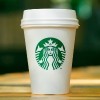 Tall Starbucks to go cup on wooden table