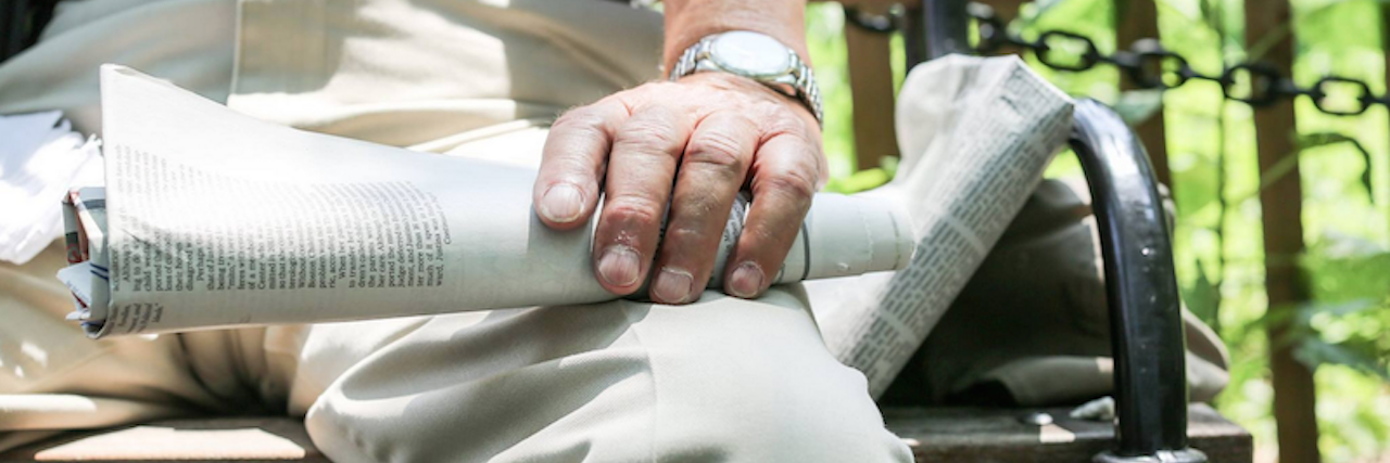 HONY Features Man With Alzheimer's Who Loses Memory But Not Friends humans of new york image of man sitting on bench holding newspaper