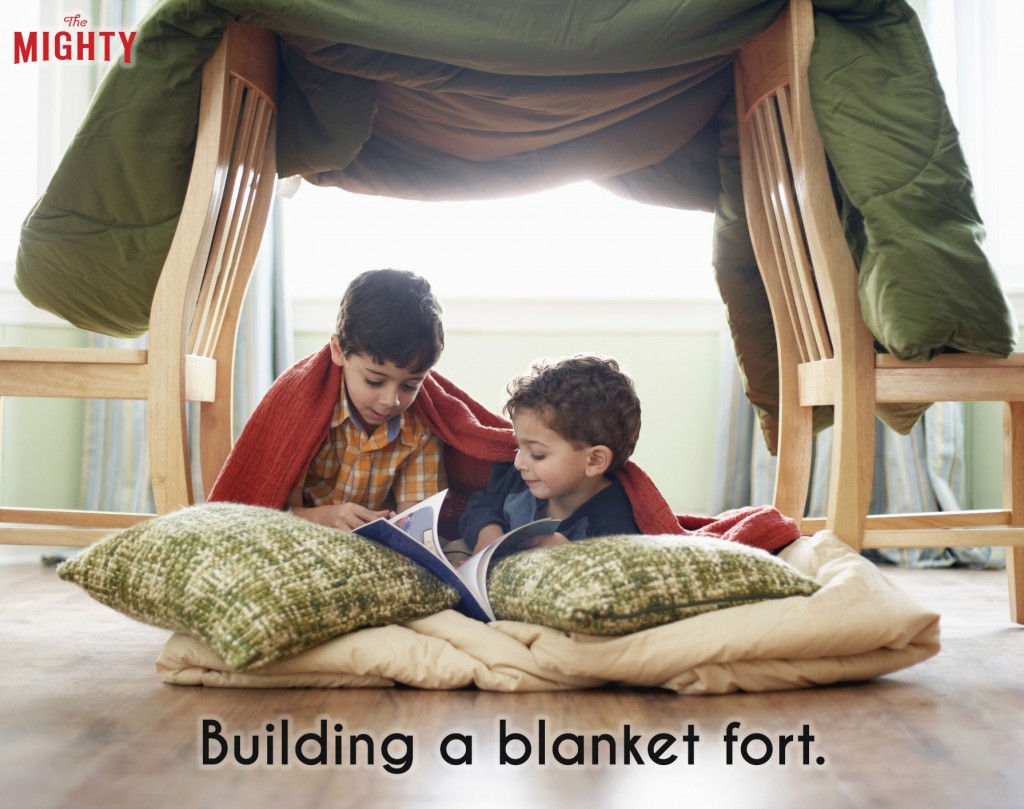 An image of two kids under a blanket fort with pillows. Accompanying text: [Building a blanket fort.]