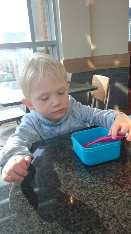 Alison's son sitting at the kitchen table